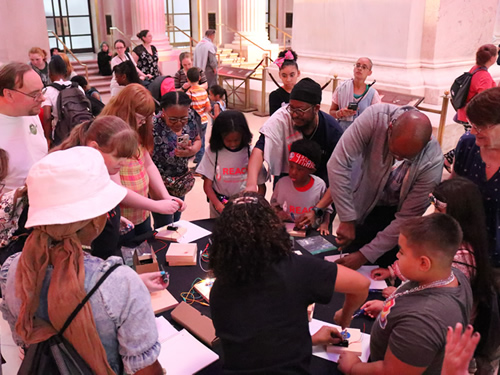 Students, parents, and staff do various activities at a back-to-school event in philadelphia.